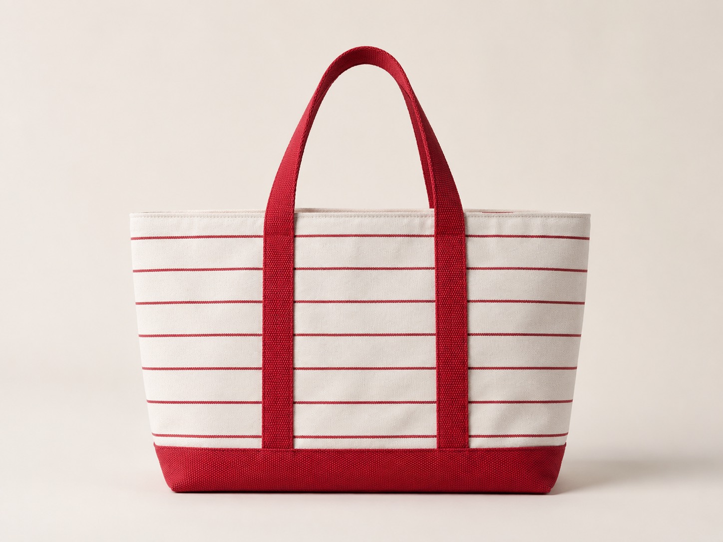 Cream canvas tote with red horizontal stripes and red webbing handles, the reference bag the client supplied